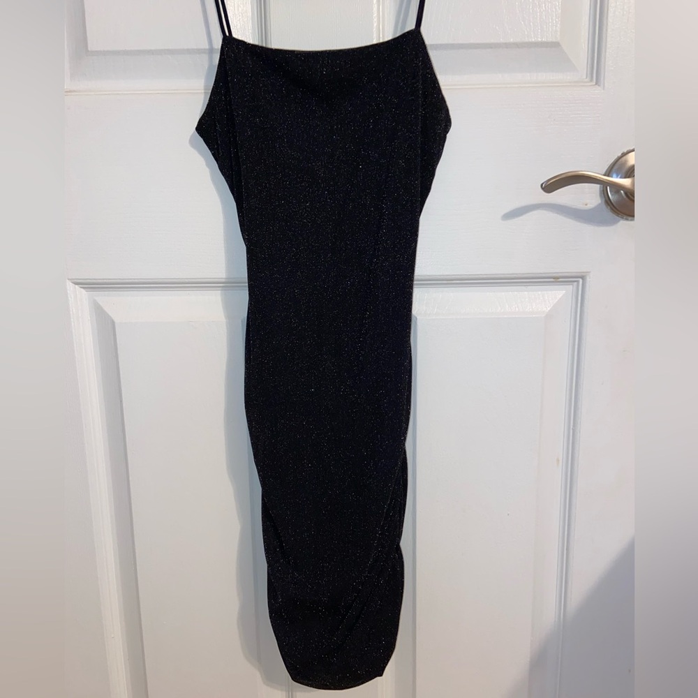 Black Glitter Spaghetti Strap bodycon Dress

Is a mini short dress